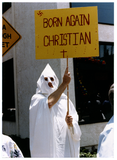 Person in KKK white robe with "Born Again Christian" sign at Pride parade, 1988