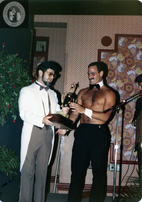 Jim Knight receives trophy for being chosen Mr. Sandie, 1982