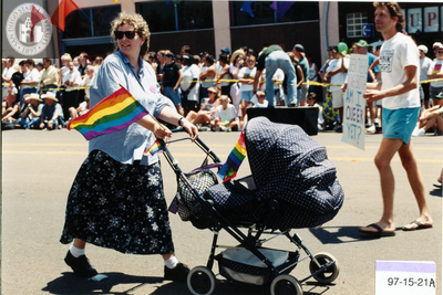 Woman pushing baby carriage at Pride parade, 1997