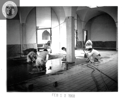 Laying quarry tile in snack bar, Aztec Center, 1968