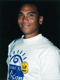 Person in a "Share the Vision" T-shirt with "Crew" button, 1997