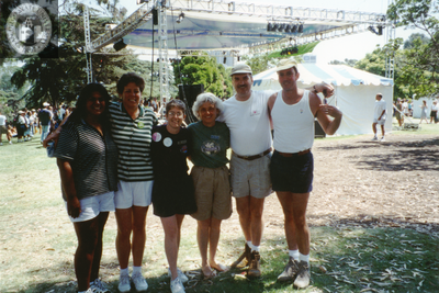 Karen Marshall and others in group portrait in front of stage at Pride festival
