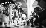 Jim Macki plays chess with unidentified students, 1975