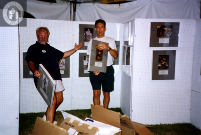 Jim Oberle and Frank Nobiletti set up booth at Pride festival, 1994