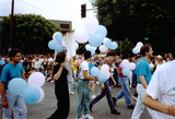 Marchers holding balloons at Pride parade, 1991
