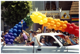 Participants waving from a truck on the Pride parade route, 1999