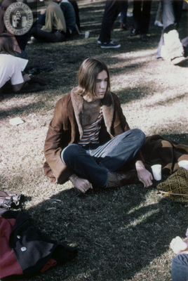 Person sits on grass at San Diego's first Gay In, Gay Liberation Front, 1970