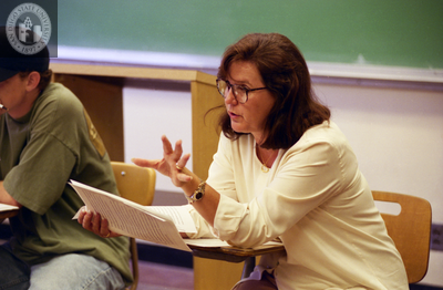 Instructor teaches class from desk chair, 1996