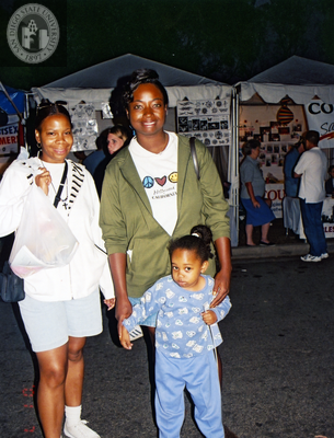 Two people with a child at Pride Festival, 2001
