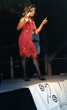 Drag queen performer wearing red dress on Pride Festival main stage, 1999