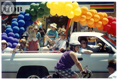Participants wave from a truck on Pride parade route, 1999