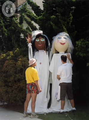 Two carnival puppets dressed in white at Commitment Ceremony, 2001