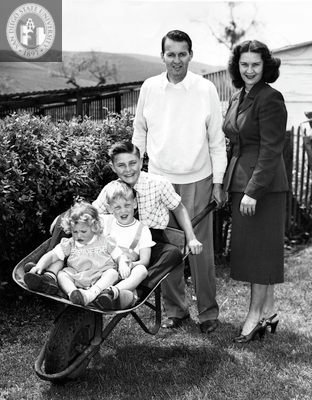 Lionel Van Deerlin and his wife, with three children in a wheelbarrow