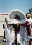 Man in costume lifting dress at Pride parade, 1996