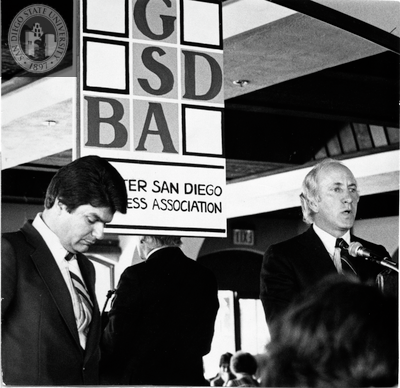 Fred Schnaubelt and George Mitrovich debating at GSDBA luncheon, 1980