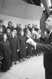 A chorus and director perform