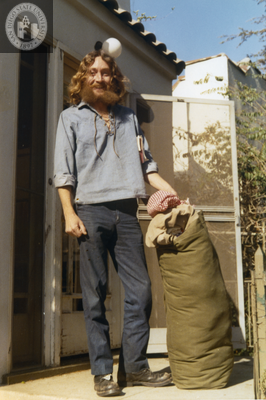 Stanley Williams standing on the steps of the Hoover Street Collective, 1971