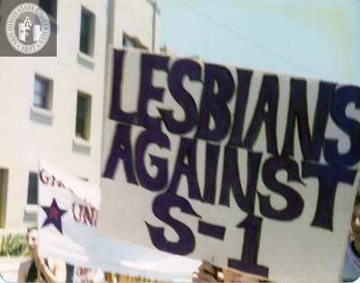 "Lesbians against S-1" sign at Pride parade, 1976