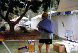 Volunteer setting up Center booth at Pride festival, 1998