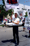 Walt Huckins holding Stonewall 25 banner in Pride parade, 1994
