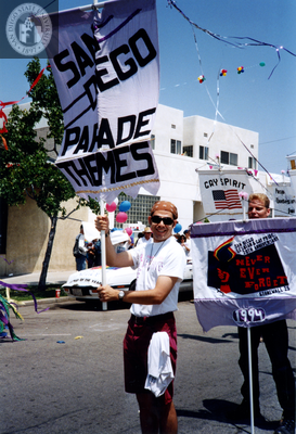 Jake holds Lesbian and Gay Historical Society banner in Pride parade, 1994