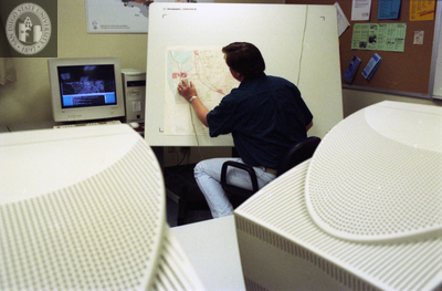 Man scanning part of map for upload, 1996