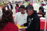 Man talks with staff of Photo ID tent, 1998