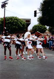 Male cheerleaders in drag in Pride parade, 1991
