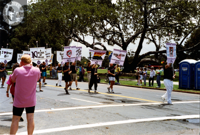 Marchers holding banners at Pride parade, 1990