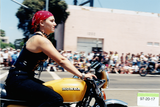 Woman on motorcycle in Pride parade, 1997