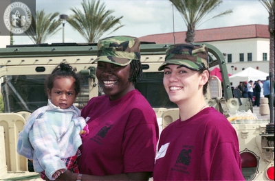 Women in Army ROTC hold an infant, 1998
