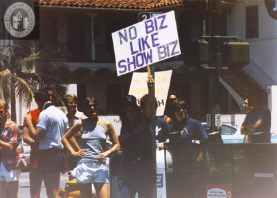 "No biz like show biz" sign at Pride parade