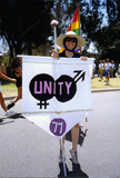 Pride parade marcher holds flag with 1977 Pride theme, 1992