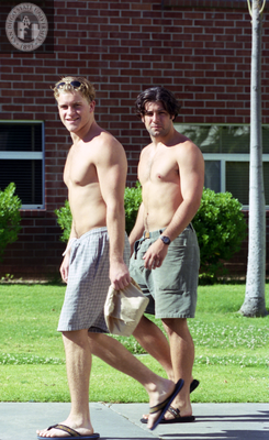 Two men students walking near brick dormitory, 1996