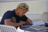 Student using calculator at Aztec Center, 1996