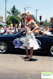 Man posing with 93.3 FM car in the Pride parade, 1997