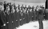 An unidentified conductor and chorus