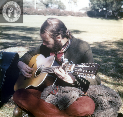 Guitar player at San Diego Gay-In II in Balboa Park, 1971