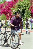 Student with bicycle walking up Hilltop Way, 1996