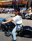 Woman on motorcycle at Pride parade, 2001