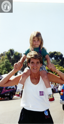 Child sits on adult's shoulders at San Diego Pride, 1995