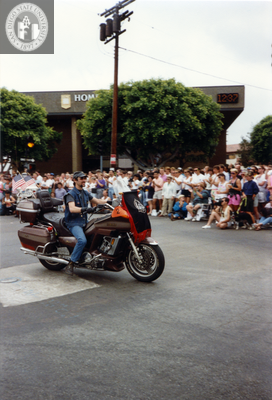 Person riding motorcycle in Pride parade, 1991