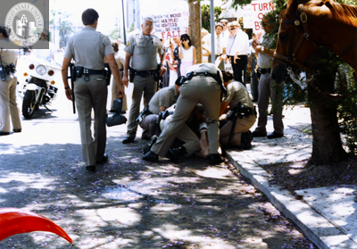 Police officers restraining Brian Barlow at Pride parade, 1986