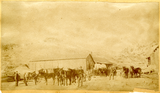 Wagons, horses, and men on the street in Flint