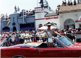 Mr. Latin Lover standing in red convertible in Pride parade, 1996