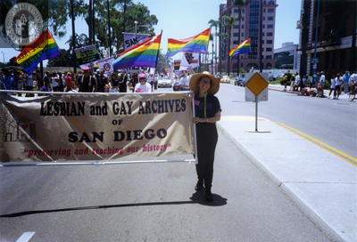 Kate Johnson holds up her end of the Lesbian and Gay Archives banner, 1992