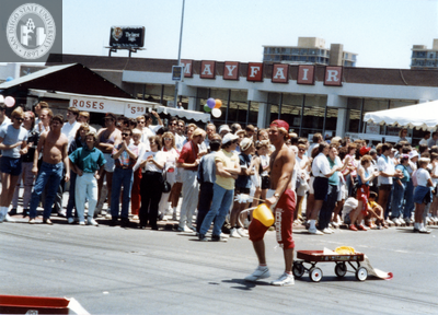 Person pulling red wagon in Pride parade, 1988