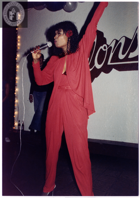Individual singing with one arm in the air, 1982