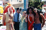 Pride parade participants in costume in front of Stonewall float, 1999