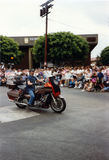 Person riding motorcycle in Pride parade, 1991